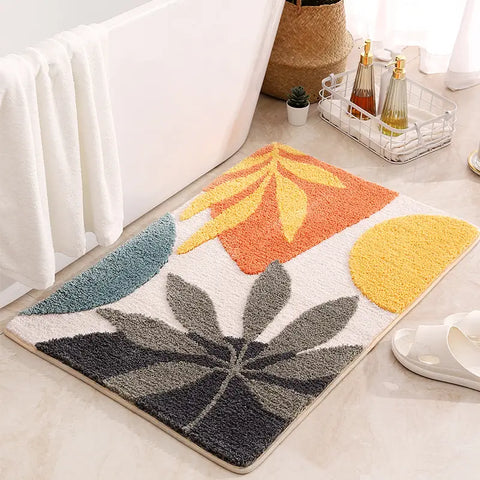 abstract bath mat with geometric floral design in orange, yellow, and teal tones