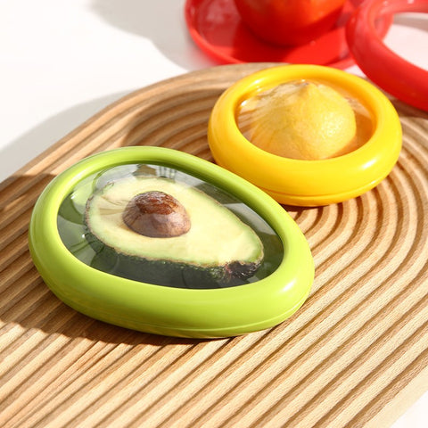 Two circular food container covers in green and yellow colors, designed to keep produce fresh.
