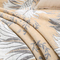 Fabric detail of reversible beige cotton jacquard blanket with tassels