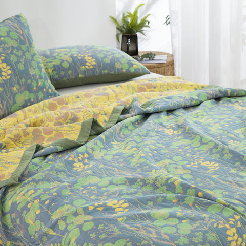  Reversible botanical cotton quilt with soft plant motifs styled in sunlit bedroom