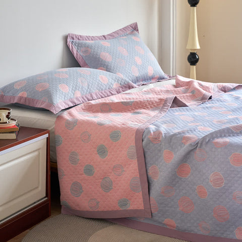 Polka dot bedding set on a bed in a bedroom setting