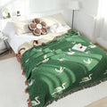 Cotton gauze swan blanket in minimalist bedroom, reversible green and cream