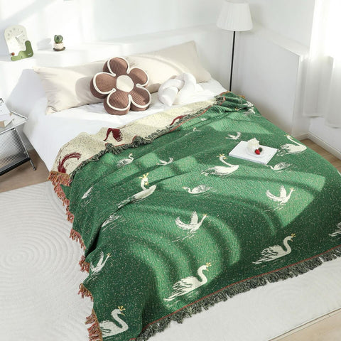 Cotton gauze swan blanket in minimalist bedroom, reversible green and cream