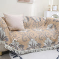 Reversible cotton couch cover blanket with tassels styled as a full sofa cover