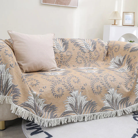 Reversible cotton couch cover blanket with tassels styled as a full sofa cover