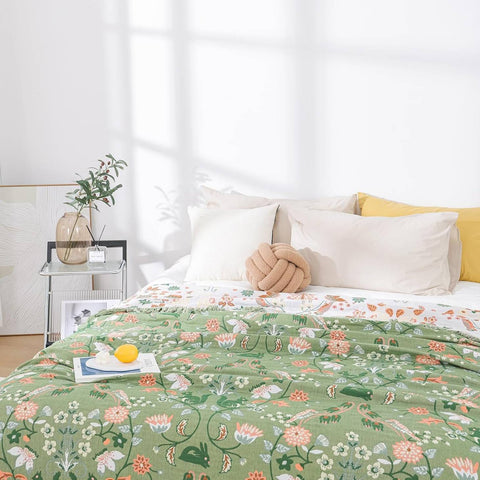 Bed with floral patterned comforter in a bright bedroom
