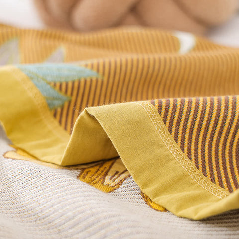 Edge detail of sunflower quilt showing reversible stitching and striped trim