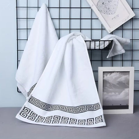 Round stacked towels with Greek patterns and soap