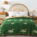 Royal Goose reversible cotton tassel blanket on bed in natural rattan bedroom
