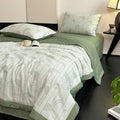 Gauze cotton bedding set in soft sage with quilt and pillowcases on bed