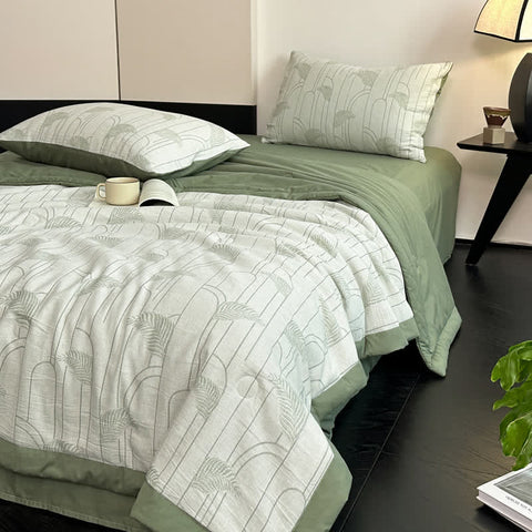 Gauze cotton bedding set in soft sage with quilt and pillowcases on bed