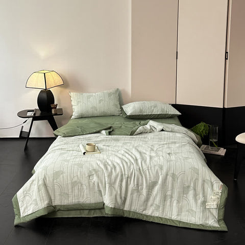 Full view of cotton gauze bedding set in sage green with modern leaf pattern