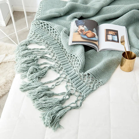 Sage Green Handmade Nordic Knit Tassel Blanket on modern chair – Scandinavian décor