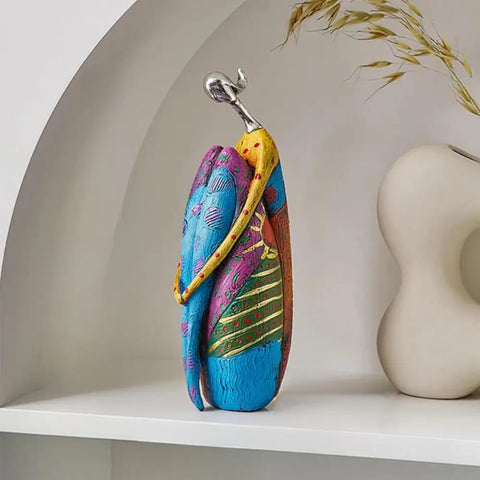 Seated resin sculpture for home decor shelves or living room styling

