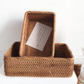 Set of small rattan baskets on white surface