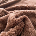 Ultra soft brown fleece blanket edge showing fluffy texture and cozy warmth