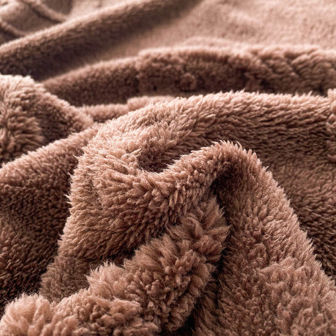 Ultra soft brown fleece blanket edge showing fluffy texture and cozy warmth