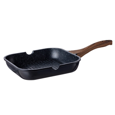 Black speckled grill pan with wooden handle on a white background