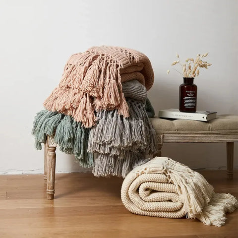 Stack of Nordic Knit Tassel Blankets in Sage Green, Dusty Rose, and Ivory Cream