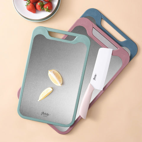 Set of colorful cutting boards with a knife on a beige background