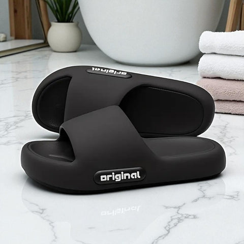 Black slides with 'original' branding on a marble surface