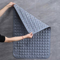 Woman lifting corner of waterproof suction bath mat