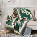 Terra Azul tribal throw blanket styled on beige sofa with green and burgundy pattern