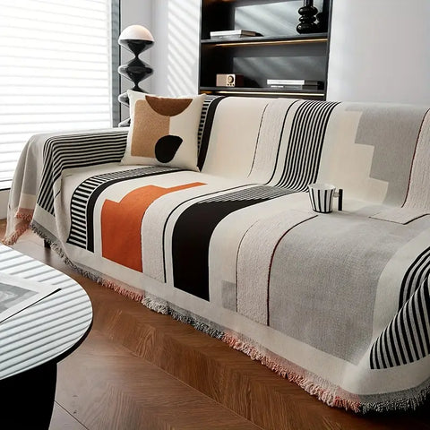 Modern boho sofa cover with terracotta, black, and beige abstract design on couch