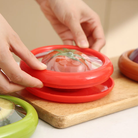 Tomato being sealed in red reusable food container