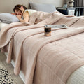  Woman sleeping under light coffee brown quilt on bed