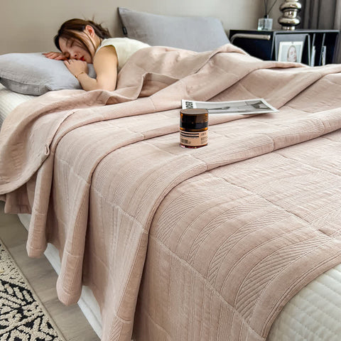  Woman sleeping under light coffee brown quilt on bed