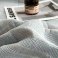 Close-up of light blue muslin quilt texture and weave pattern