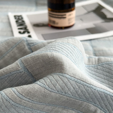 Close-up of light blue muslin quilt texture and weave pattern