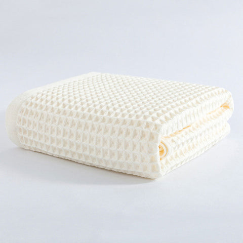 Cream white folded waffle weave towel with soft texture