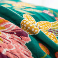 Detailed close-up of colorful floral jacquard weaving on Wildflower Grove Cotton Throw Blanket
