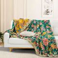 Wildflower Grove Cotton Throw Blanket draped over white sofa with decorative pillow
