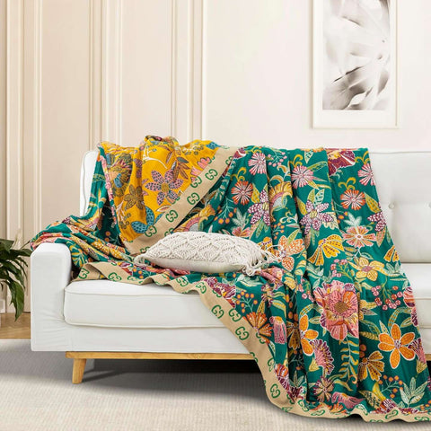 Wildflower Grove Cotton Throw Blanket draped over white sofa with decorative pillow