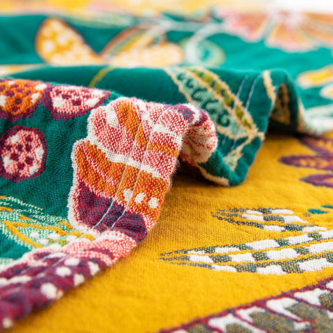 Close-up of vibrant floral print and fabric edge stitching on Wildflower Grove Cotton Throw Blanket
