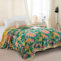 Wildflower Grove Throw Blanket displayed on bed with bright floral pattern and green accents