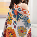 Woman standing wrapped in Daisy Flower Cotton Blanket showing colorful floral design