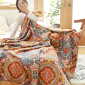 Woman stretching large bohemian quilt next to bed