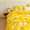 Modern yellow floral bedding set styled in bright bedroom with colorful sheets